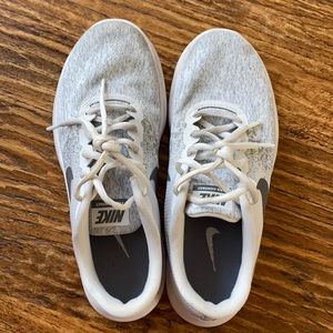 Gray and white Nike tennis shoes